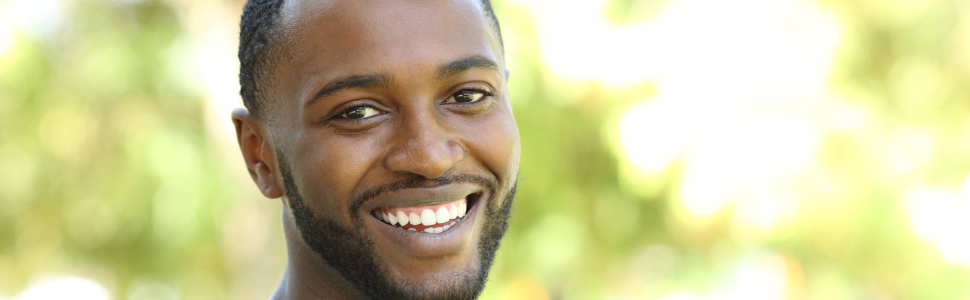 A man smiling after dental bridges treatments