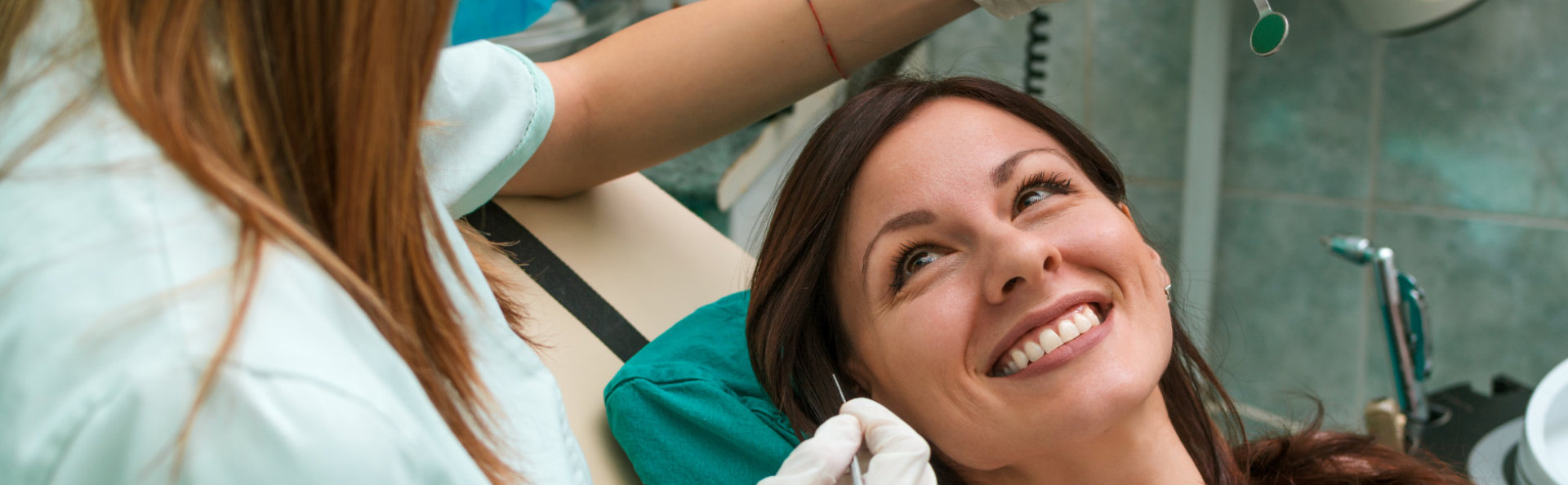 A beautiful woman is smiling after root canals treatment