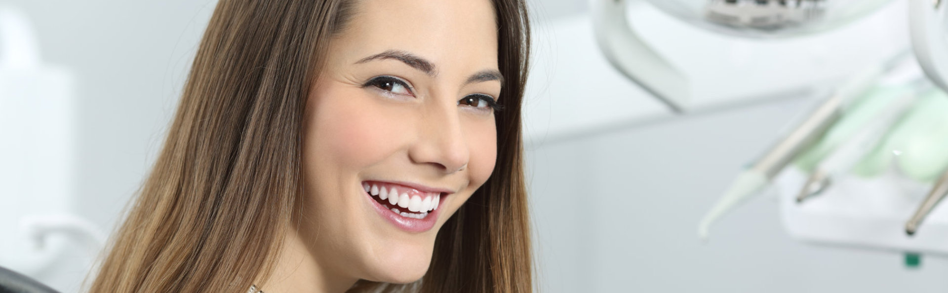 A beautiful woman is smiling after laser dentistry